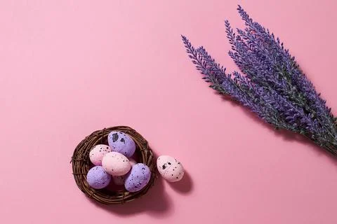 Close Up of Colorful Easter Eggs in the nest with lavender bouquet on the pin Stock Photos