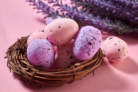 Close Up of Colorful Easter Eggs in the nest with lavender bouquet on the pin Stock Photos