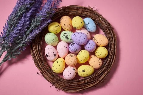 Close Up of Colorful Easter Eggs in the nest with lavender bouquet on the pin Stock Photos