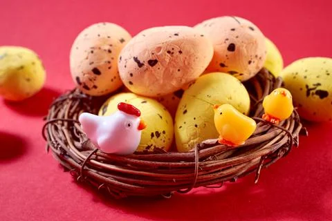 Close Up of Colorful Easter Eggs with small hen and chikens in the nest on th Stock Photos