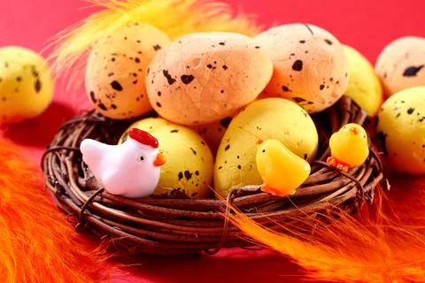 Close Up of Colorful Easter Eggs with small hen and chikens in the nest on th Stock Photos
