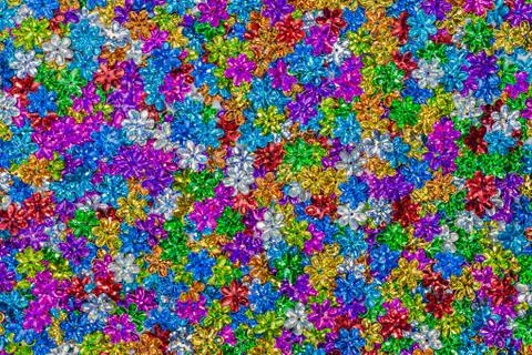 Close up colorful flower glitter in pattern. flower shape glitters in top vie 库存照片