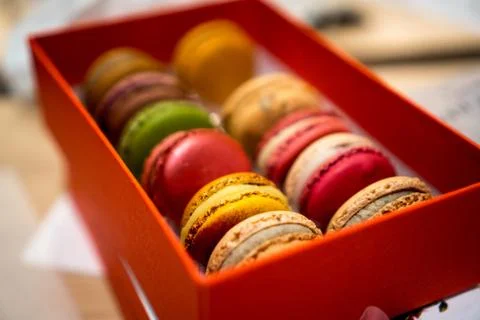 Close up of colorful macrons in a red orange box in france Stock Photos