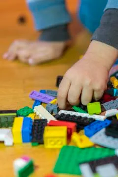 Close up of colorful plastic bricks on the floor. Early learning. Children's  Stock Photos