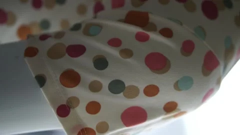 Close on a colorful polka dot pattern clothe. Vertical video. Stock Footage 141475543