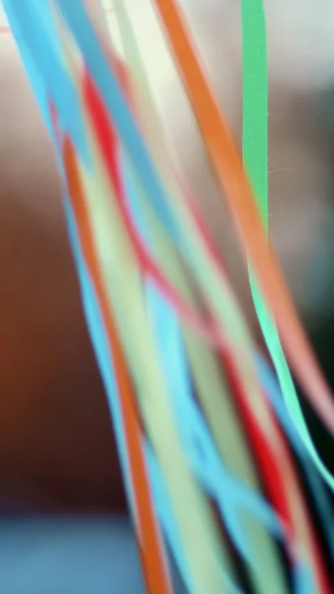 Close-up, colorful ribbons developing in wind, blurred background Stock Footage 317940641