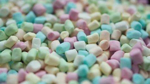 Close up of colorful scattered blurred marshmallows with rotation motion Stock Footage 296758488