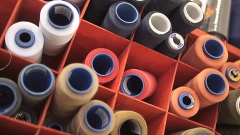 Close up of colorful sewing spools in the organizer in design studio. Stock Footage 88484112