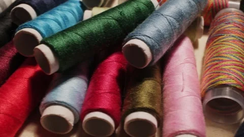 Close-up of colorful sewing thread spools highlighting vibrant textures and.. Stock Footage 312552240