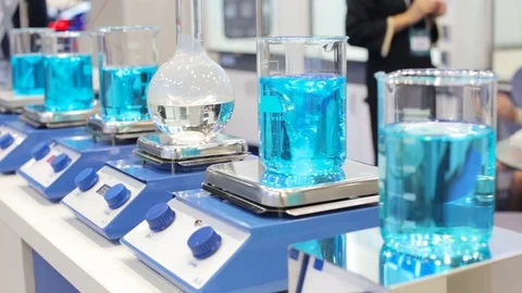 Close-up of colorful test tubes in which the liquid is mixed by a special device Stock Footage 81388169