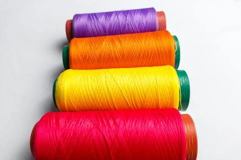 Close up of colorful threads on a white background Фото