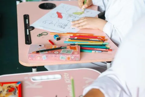 Close up coloring elementary school child's hands at the table, unknown, go.. Stock Photos