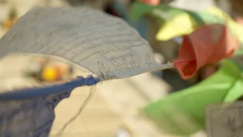 Close up Colourful Buddhist prayer flags flutter over city street Stock Footage 282527193