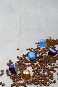 Close up colourful coffee capsules with some roasted grains on concrete Stock Photos