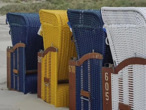 Close-up of colourful patterned beach chairs on the beachy shore, colourful Stock Photos