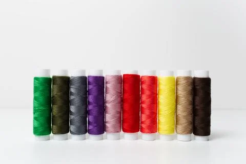 Close-up of colourful thread spools isolated on white background. Studio phot Stock Photos