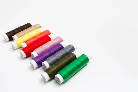 Close-up of colourful thread spools on white background. Studio photo. Stock Photos