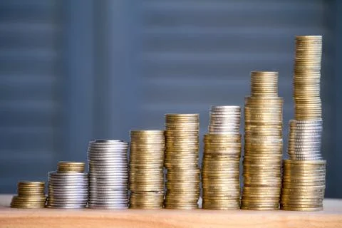 Close-up of columns of multi-colored coins of increasing height, the concept  Stock Photos