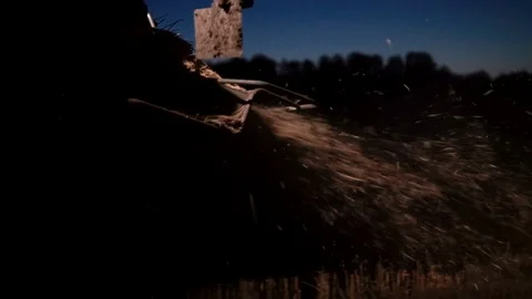 Close-up combine straw chopper at night harvesting Stock-Footage 98128689