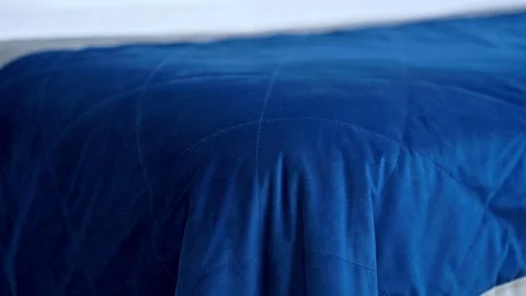 Close up of a comfortable blue quilted bed cover Stock Footage 334943021