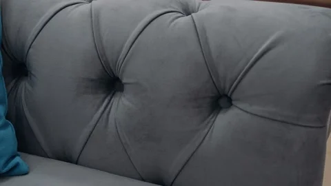 Close-up of a comfortable gray sofa. 4k video. Stock Footage 231689061