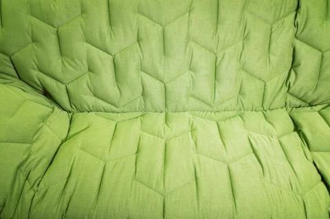 Close-up comfortable green soft sofa with curly stitching. Modern design Stock Photos