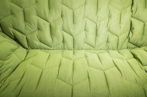 Close-up comfortable green soft sofa with curly stitching. Modern design Stock Photos