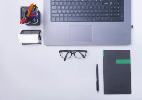 Close-up of comfortable working place in office with laptop, notebook, glasses Stock Photos