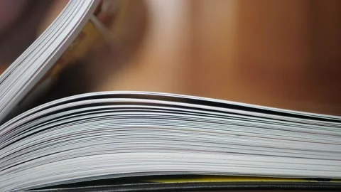 Close-up of a comic book, book pages. Hand turning pages in a Slow Mo. Pages Stock-Footage 136027876