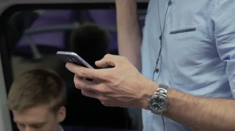 Close-up of commuter using his smartphone Stock Footage 67261253