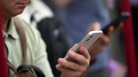 Close-up of commuter using phone in Hong Kong metro Stock Footage 314575567