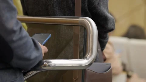 Close-up of commuter using phone near escalator or barrier Stock Footage 342060086