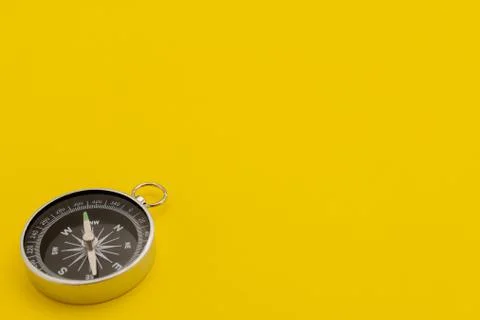 Close-Up Of Compass Against Yellow Background Stock Photos
