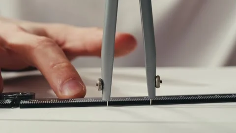 Close-up of compass drawing on white paper macro. Making some circle and Stock Footage 273361422