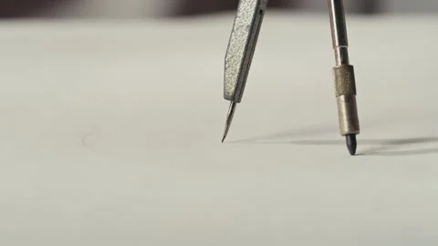 Close-up of compass drawing on white paper macro. Making some circle and Stock Footage 276111489