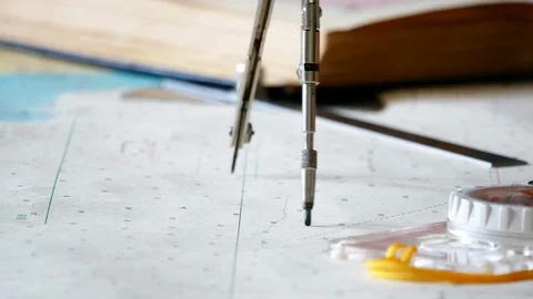 Close up of a compass that draws a long arc on the sea map. Stock Footage 130164133