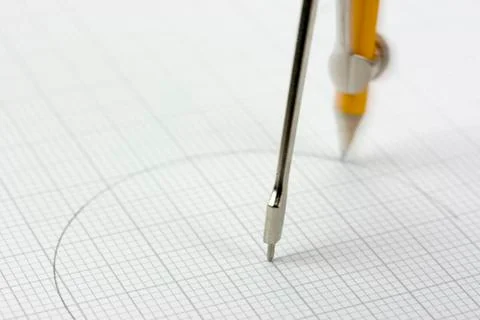 Close up of a compass on graph paper Stock Photos