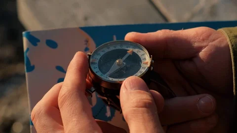 Close up on compass instrument in gloved hand . Mountain hiking trails. Fores Stock Footage 109194806