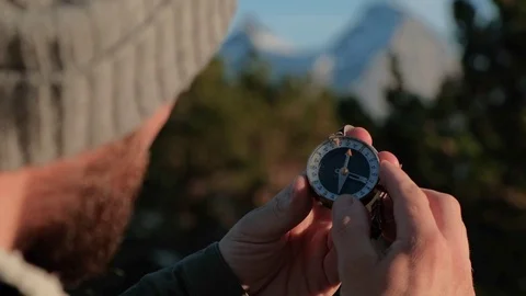 Close up on compass instrument in gloved hand . Mountain hiking trails. Fores Stock Footage 109195172