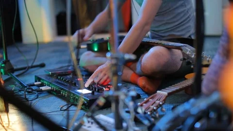 Close-up composer tunes mixer while playing musicians Stock Footage 115064724