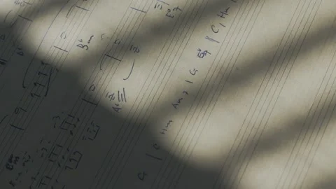 Close up of a composer working with musical notation and chord progressions in Stock Footage 346800095