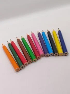 Close-up composition of colored pencils one after another on a white background Stock Photos