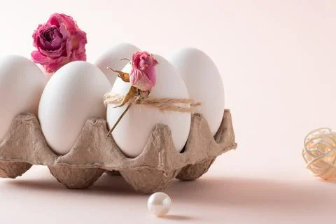 A close-up composition with Easter eggs and an eco-decor of dried roses and a Stock Photos