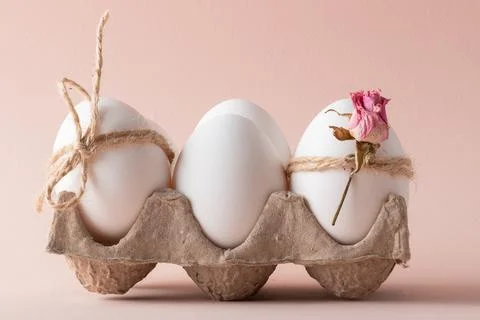 A close-up composition with Easter eggs and an eco-decor of dried roses and a Stock Photos