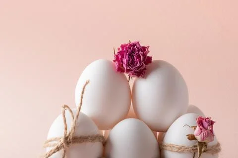 A close-up composition with Easter eggs and an eco-decor of dried roses and a Stock Photos