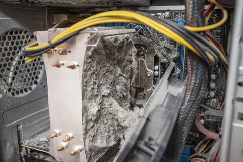 Close-up of a computer cooling system radiator clogged with dust and can no l Stock Photos
