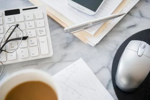 Close up of computer equipment, files and coffee on office desk Stock Photos
