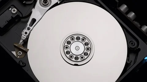 Close-Up Computer Hard Drive Spin Write. Rotation Stop. Blue Lights. Slow Motion Stock Footage 129607447