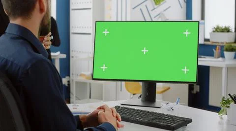 Close up of computer with horizontal green screen on desk Stock Photos