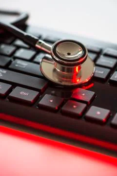 Close up of computer keyboard and stethoscope, studio shot Stock Photos